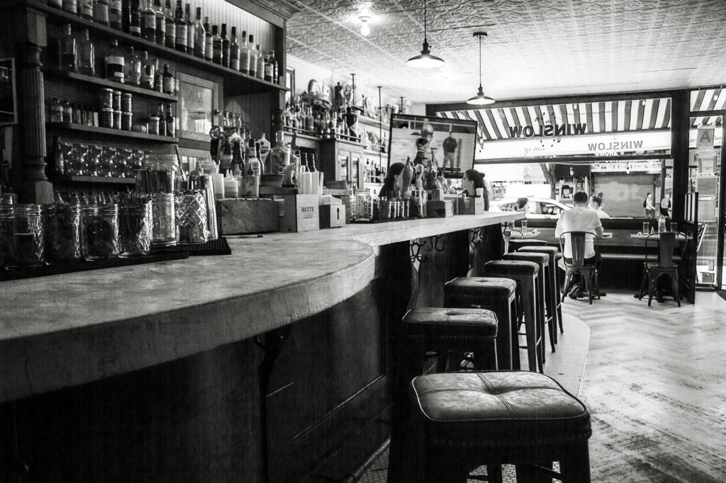 Black and white photo of The Winslow bar showing view from inside for about us page.