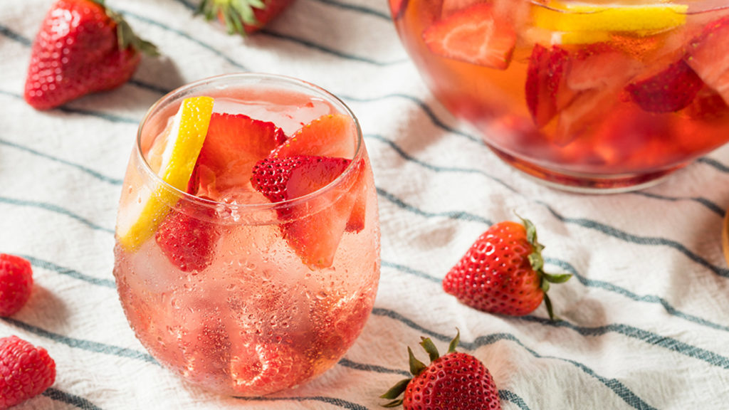 Image of a gin and tonic with strawberries that asks the question, what does your gin say about you?