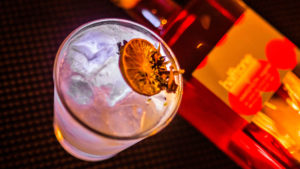 Photo of a bottle of Halftone gin and a gin beverage for celebrating Ginuary at The Winslow.