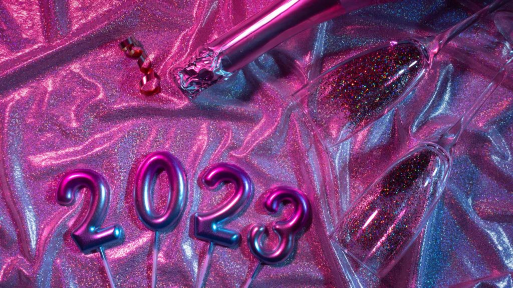 Image of purple 2023 and champagne bottle representing ideas on where to go on New Year’s Eve in NYC
