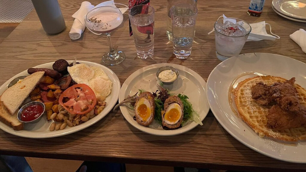Things to Do in Union Square NYC in Spring 2023 include delicious brunch items at The Winslow NYC. Photo includes an English breakfast, scotch eggs and chicken and waffles.