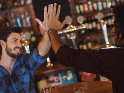 Photo of two guys high fiving in celebration of winning Monday Night NYC Trivia League at The Winslow 