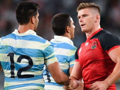 two rugby players shaking hands from england and argentina