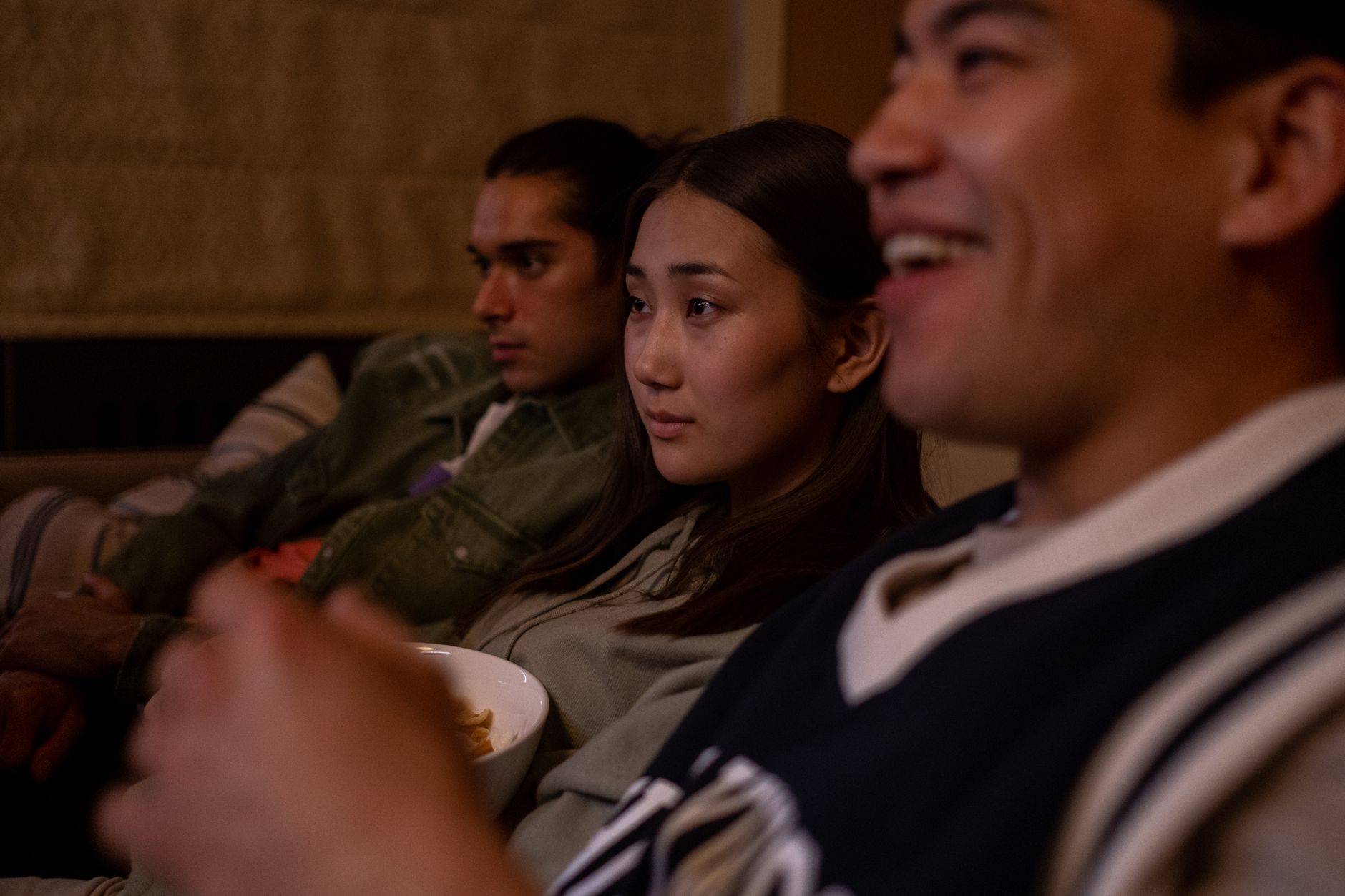 Friends watching a game together with snacks