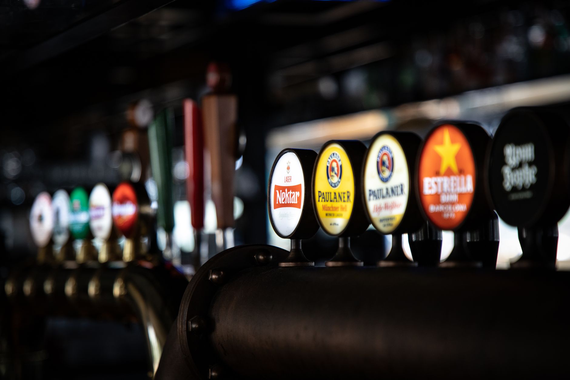 Beer taps lined up on a bar counter