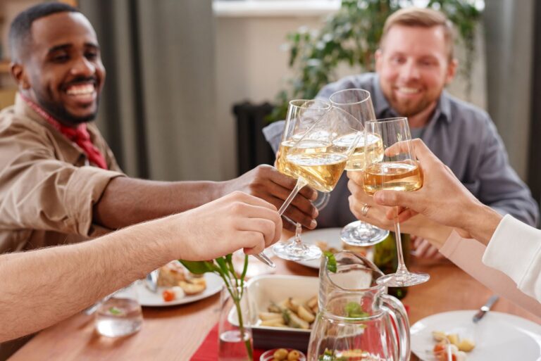 Friends toasting with wine glasses at a reserved table